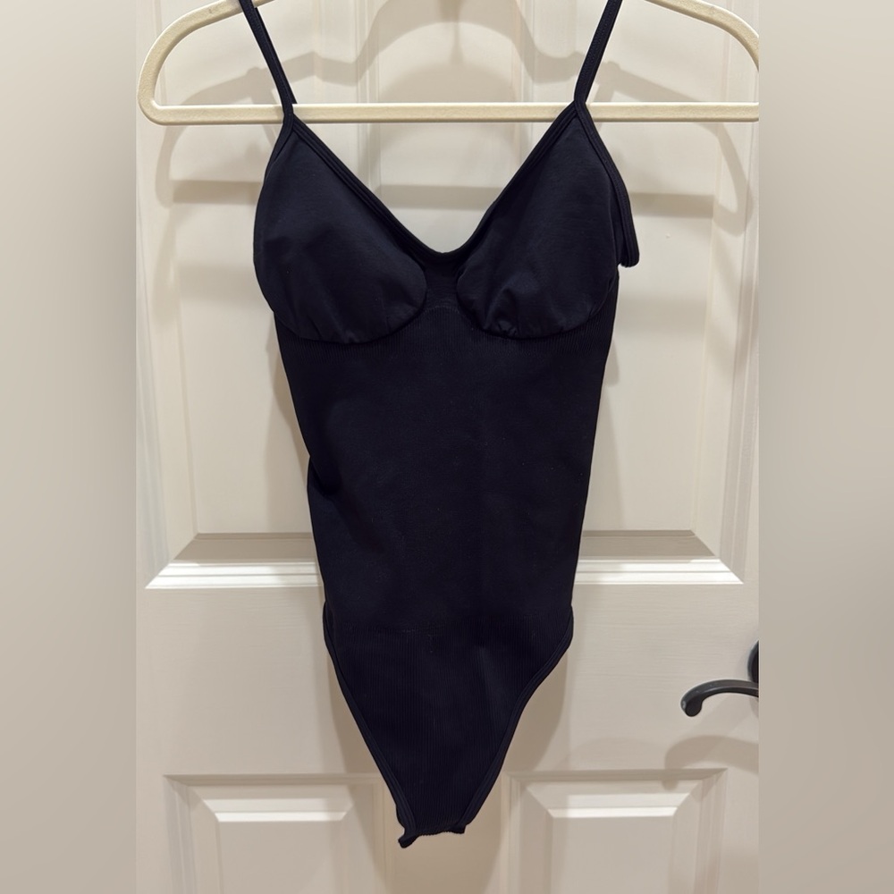 Sleek and simple black‎ body-shaping bodysuit, size small.